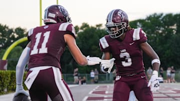 First Baptist Academy's Jayden Petit (3) celebrates with Landon Wolny against the Estero Wildcats in the season opener at First Baptist Academy in Naples on Friday, Aug. 25, 2023. The Lions defeated the Wildcats 40-7.