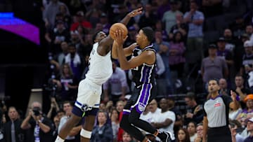 Oct 24, 2024; Sacramento, California, USA; Sacramento Kings forward Keegan Murray (13) shoots the ball against Minnesota Timberwolves guard Anthony Edwards (5) during the fourth quarter at Golden 1 Center. Mandatory Credit: Sergio Estrada-Imagn Images