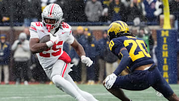 Ohio State Buckeyes running back Bo Jackson (25) runs past Michigan Wolverines defensive back Jyaire Hill (20) during the NCAA football game at Michigan Stadium in Ann Arbor, Mich. on Nov. 29, 2025. Ohio State won 27-9.