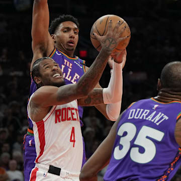 Mar 30, 2025; Phoenix, Arizona, USA; Houston Rockets guard Jalen Green (4) drives between Phoenix Suns forward Kevin Durant (35) and center Oso Ighodaro in the first half at Footprint Center. Mandatory Credit: Rick Scuteri-Imagn Images