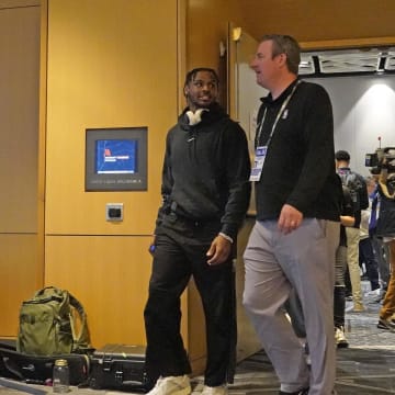 May 14, 2024; Chicago, IL, USA; Bronny James leaves with Tim Frank VP of Communications for the NBA after talking to the media during the 2024 NBA Draft Combine  at Wintrust Arena. Mandatory Credit: David Banks-USA TODAY Sports