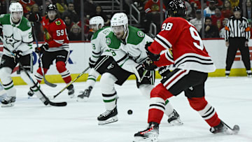 Dec 29, 2024; Chicago, Illinois, USA;  Chicago Blackhawks center Connor Bedard (98) scores a goal past Dallas Stars defenseman Ilya Lyubushkin (46) during the first period at United Center. Mandatory Credit: Matt Marton-Imagn Images