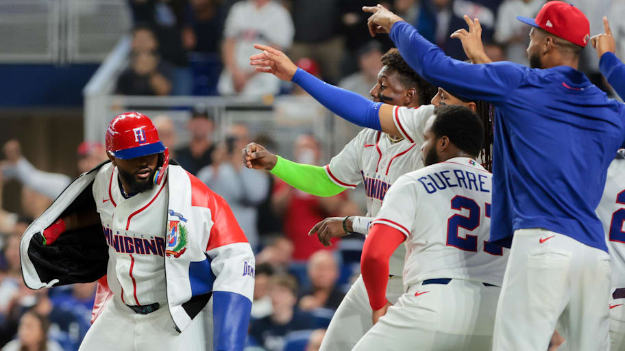 Dominican Republic designated hitter Junior Caminero, left, celebrates with his teammates