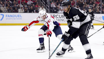 Mar 13, 2025; Los Angeles, California, USA; Washington Capitals defenseman Trevor van Riemsdyk (57) lunges for the puck against Los Angeles Kings right wing Quinton Byfield (55) during the second period at Crypto.com Arena. Mandatory Credit: Ryan Sun-Imagn Images