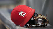 Sep 17, 2018; Atlanta, GA, USA; Detailed view of a St. Louis Cardinals hat and glove in the dugout against the Atlanta Braves in the first inning at SunTrust Park. Mandatory Credit: Brett Davis-Imagn Images
