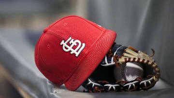 Sep 17, 2018; Atlanta, GA, USA; Detailed view of a St. Louis Cardinals hat and glove in the dugout against the Atlanta Braves in the first inning at SunTrust Park. Mandatory Credit: Brett Davis-Imagn Images
