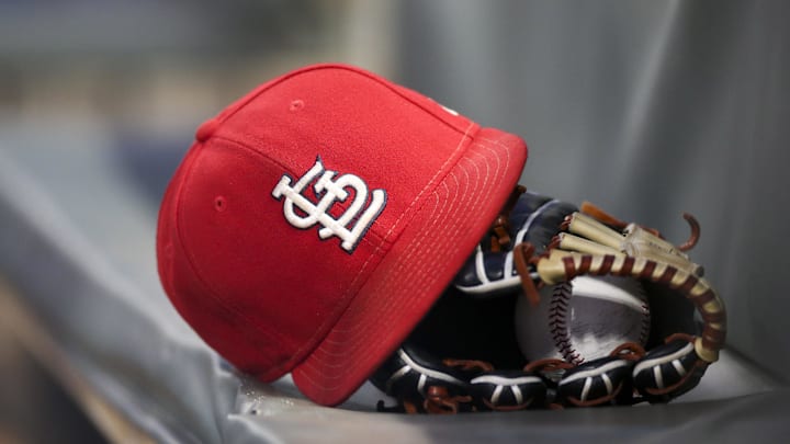 Sep 17, 2018; Atlanta, GA, USA; Detailed view of a St. Louis Cardinals hat and glove in the dugout against the Atlanta Braves in the first inning at SunTrust Park. Mandatory Credit: Brett Davis-Imagn Images
