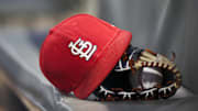 Sep 17, 2018; Atlanta, GA, USA; Detailed view of a St. Louis Cardinals hat and glove in the dugout against the Atlanta Braves in the first inning at SunTrust Park. Mandatory Credit: Brett Davis-Imagn Images
