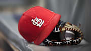 Sep 17, 2018; Atlanta, GA, USA; Detailed view of a St. Louis Cardinals hat and glove in the dugout against the Atlanta Braves in the first inning at SunTrust Park. Mandatory Credit: Brett Davis-Imagn Images

