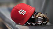 Sep 17, 2018; Atlanta, GA, USA; Detailed view of a St. Louis Cardinals hat and glove in the dugout against the Atlanta Braves in the first inning at SunTrust Park. Mandatory Credit: Brett Davis-Imagn Images
