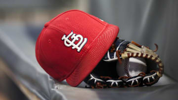 Sep 17, 2018; Atlanta, GA, USA; Detailed view of a St. Louis Cardinals hat and glove in the dugout against the Atlanta Braves in the first inning at SunTrust Park. Mandatory Credit: Brett Davis-Imagn Images
