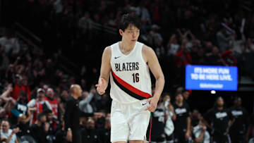 Oct 10, 2025; Portland, Oregon, USA;  Portland Trail Blazers center Yang Hansen  (16) reacts after making a three point shot against Sacramento Kings in the second half at Moda Center. Mandatory Credit: Jaime Valdez-Imagn Images