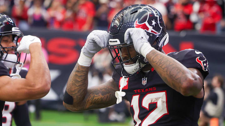 Dec 14, 2025; Houston, Texas, USA; Houston Texans wide receiver Xavier Hutchinson (19) celebrates wide receiver Nico Collins (12) touchdown against the Arizona Cardinals in the fourth quarter at NRG Stadium. Mandatory Credit: Thomas Shea-Imagn Images