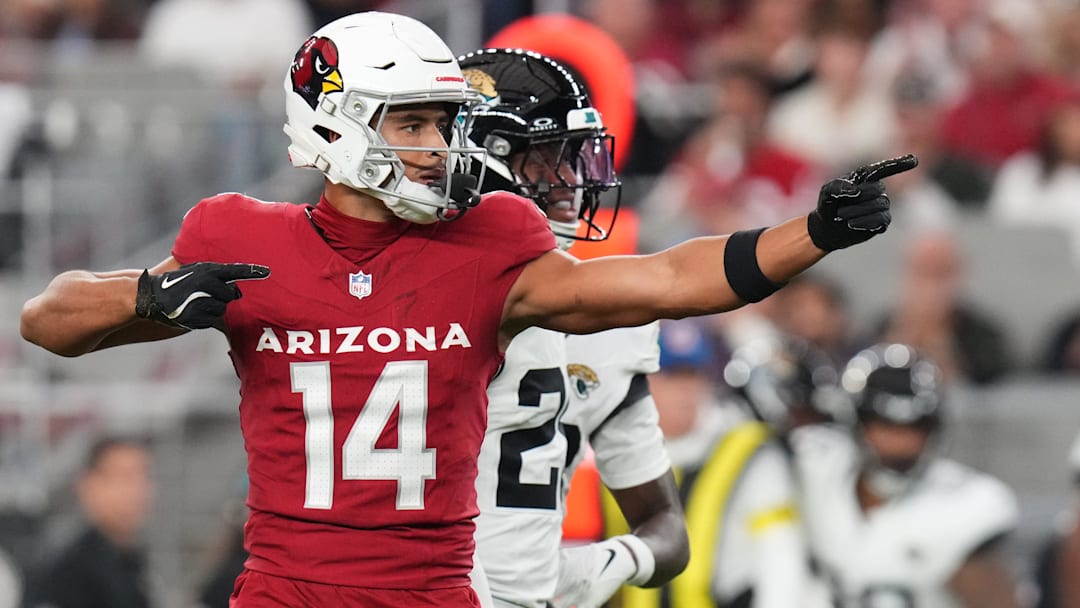 Arizona Cardinals receiver Michael Wilson (14) signals a first down after his catch against the Jacksonville Jaguars at State Farm Stadium on Nov. 23, 2025.