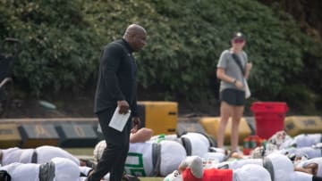 Oregon running backs coach Carlos Locklyn walks the field during practice with the Ducks Wednesday, Aug. 16, 2023.