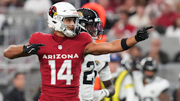 Arizona Cardinals receiver Michael Wilson (14) signals a first down after his catch against the Jacksonville Jaguars at State Farm Stadium on Nov. 23, 2025.