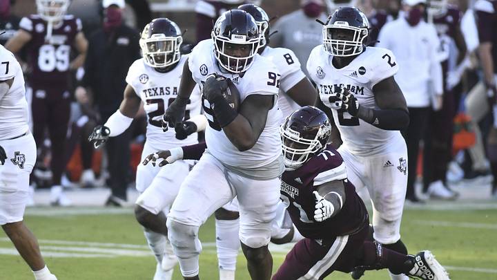 Oct 17, 2020; Starkville, Mississippi, USA;  Texas A&M Aggies defensive lineman Jayden Peevy (92) runs the ball after recovering a fumble agains the Mississippi State Bulldogs during the third quarter at Davis Wade Stadium at Scott Field. Mandatory Credit: Matt Bush-USA TODAY Sports