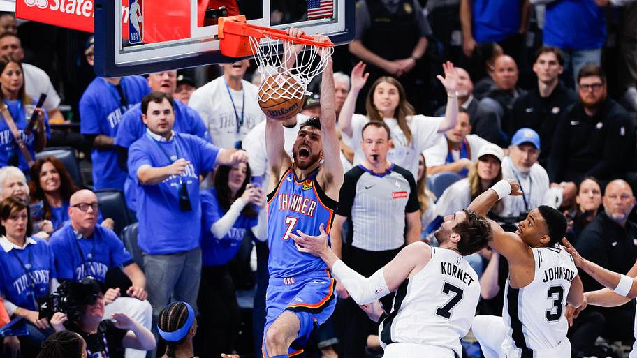 Thunder center Chet Holmgren dunks as Spurs center Luke Kornet defends.