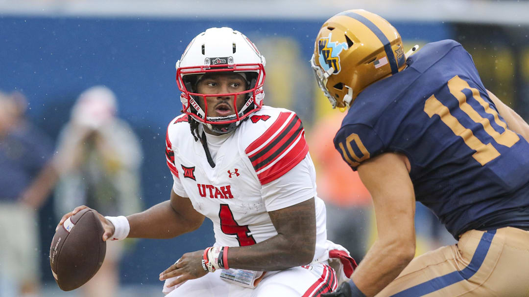 Sep 27, 2025; Morgantown, West Virginia, USA; Utah Utes quarterback Devon Dampier (4) looks to pass while being pressured by West Virginia Mountaineers linebacker Braden Siders (10) during the first quarter at Milan Puskar Stadium. Sep 27, 2025; Morgantown, West Virginia, USA; Utah Utes quarterback Devon Dampier (4) looks to pass while being pressured by West Virginia Mountaineers linebacker Braden Siders (10) during the first quarter at Milan Puskar Stadium.