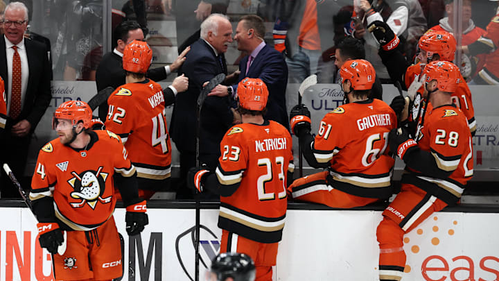 Feb 25, 2026; Anaheim, California, USA;  Anaheim Ducks head coach Joel Quenneville (back row, middle) celebrates with his coaching staff and players after winning his 1,000th career coaching victory with a 6-5 win over the Edmonton Oilers at Honda Center. Mandatory Credit: Kiyoshi Mio-Imagn Images