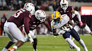 Oct 24, 2025; Blacksburg, Va.; California running back Kendrick Raphael (1) runs after a catch as Virginia Tech defensive lineman Kemari Copeland (13) defends.