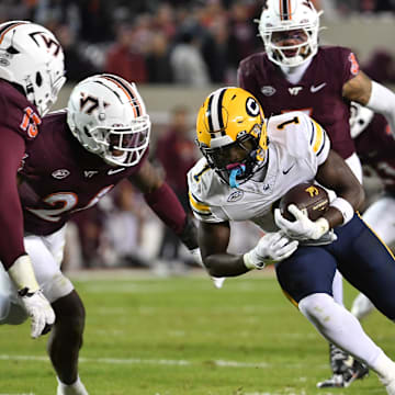 Oct 24, 2025; Blacksburg, Va.; California running back Kendrick Raphael (1) runs after a catch as Virginia Tech defensive lineman Kemari Copeland (13) defends.