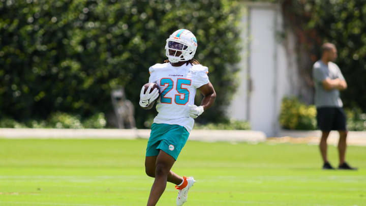 Jun 4, 2024; Miami Gardens, FL, USA; Miami Dolphins running back Jaylen Wright (25) runs with the football during mandatory minicamp at Baptist Health Training Complex. Mandatory Credit: Sam Navarro-USA TODAY Sports