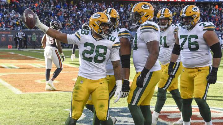 Green Bay Packers running back AJ Dillon (28), celebrates a touchdown run vs. the Chicago Bears.