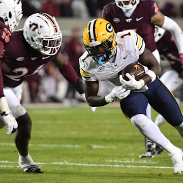 Cal running back Kendrick Raphael tries to gain yardage vs. Virginia Tech