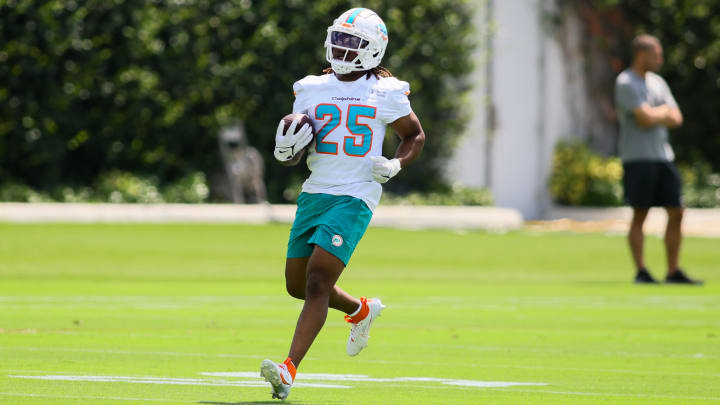 Jun 4, 2024; Miami Gardens, FL, USA; Miami Dolphins running back Jaylen Wright (25) runs with the football during mandatory minicamp at Baptist Health Training Complex. Mandatory Credit: Sam Navarro-USA TODAY Sports