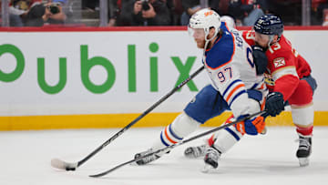 Jun 17, 2025; Sunrise, Florida, USA; Edmonton Oilers center Connor McDavid (97) controls the puck defended by Florida Panthers center Sam Reinhart (13) during the first period in game six of the 2025 Stanley Cup Final at Amerant Bank Arena. Mandatory Credit: Sam Navarro-Imagn Images