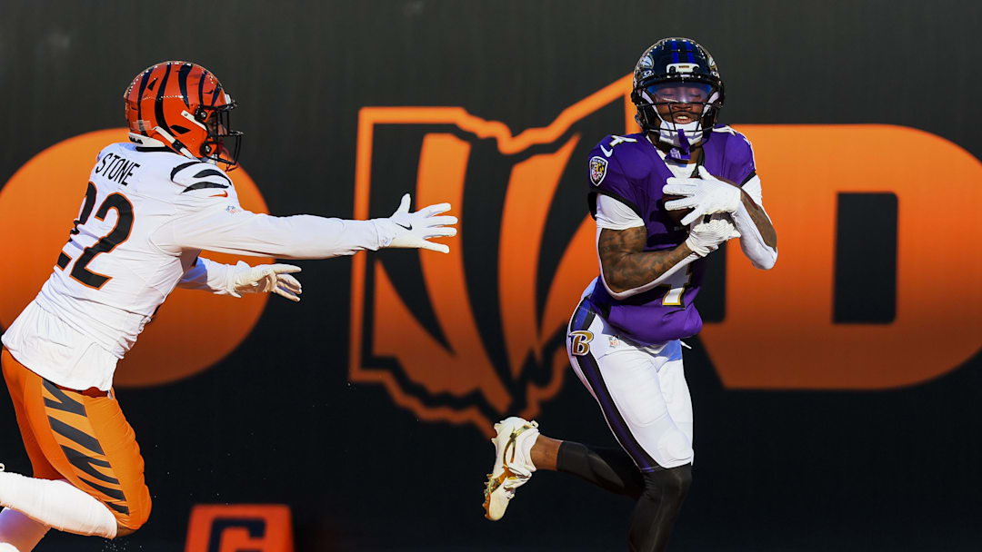 Dec 14, 2025; Cincinnati, Ohio, USA; Baltimore Ravens wide receiver Zay Flowers (4) catches a pass for a touchdown in the first half against Cincinnati Bengals safety Geno Stone (22) at Paycor Stadium. Mandatory Credit: Katie Stratman-Imagn Images
