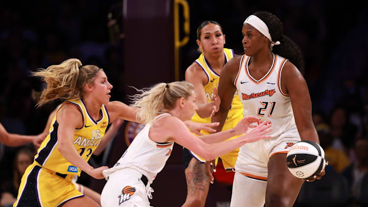 Jun 1, 2025; Los Angeles, California, USA;  Phoenix Mercury center Kalani Brown (21) passes the ball to guard Lexi Held (1) during the third quarter against the Los Angeles Sparks at Crypto.com Arena. Mandatory Credit: Kiyoshi Mio-Imagn Images