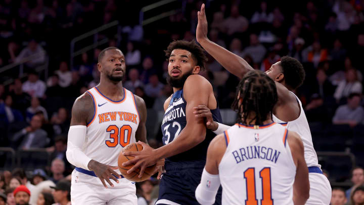 Oct 14, 2023; New York, New York, USA; Minnesota Timberwolves center Karl-Anthony Towns (32) controls the ball against New York Knicks forward Julius Randle (30) and guards RJ Barrett (9) and Jalen Brunson (11) during the first quarter at Madison Square Garden. Mandatory Credit: Brad Penner-USA TODAY Sports