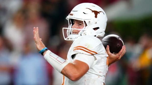 Texas Longhorns quarterback Quinn Ewers attempts a pass during a college football game in the SEC.