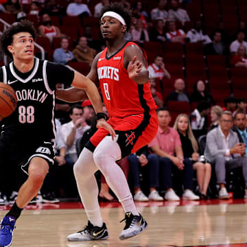 Oct 27, 2025; Houston, Texas, USA; Brooklyn Nets guard Nolan Traore (88) drives to the basket against Houston Rockets forward Jae'Sean Tate (8) during the fourth quarter at Toyota Center. Mandatory Credit: Erik Williams-Imagn Images
