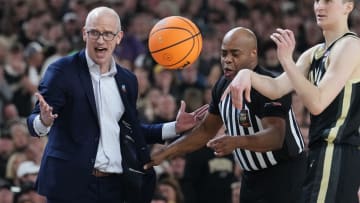 Connecticut Huskies head coach Dan Hurley is pulled back by the referee during the Men's NCAA national championship game against the Purdue Boilermakers at State Farm Stadium in Glendale on April 8, 2024.