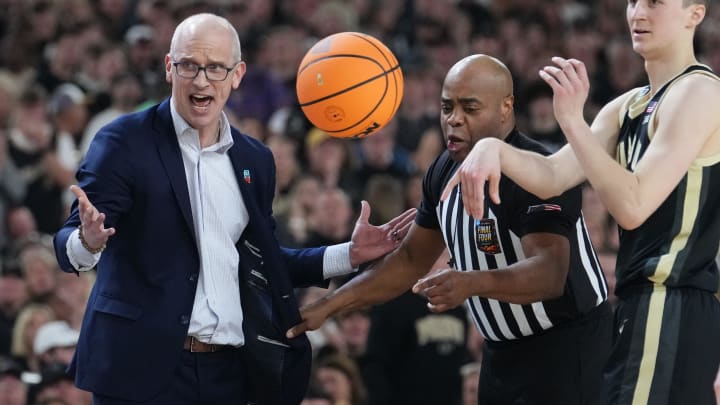 Connecticut Huskies head coach Dan Hurley is pulled back by the referee during the Men's NCAA national championship game against the Purdue Boilermakers at State Farm Stadium in Glendale on April 8, 2024.