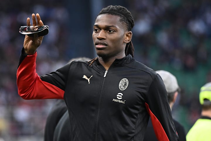 Rafael Leão waving while in a Milan training top.