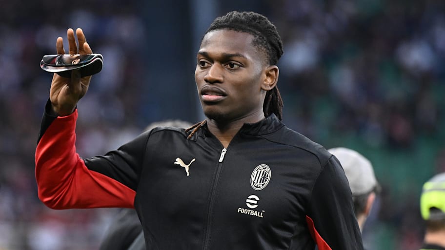 Rafael Leão waving while in a Milan training top.