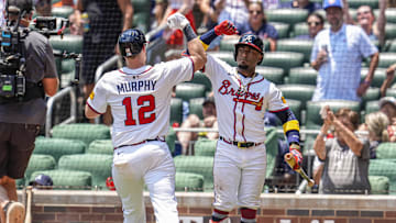 Jul 6, 2025; Cumberland, Georgia, USA; Atlanta Braves catcher Sean Murphy (12) reacts with second baseman Ozzie Albies (1)  after hitting a home run against the Baltimore Orioles during the ninth inning at Truist Park. Mandatory Credit: Dale Zanine-Imagn Images