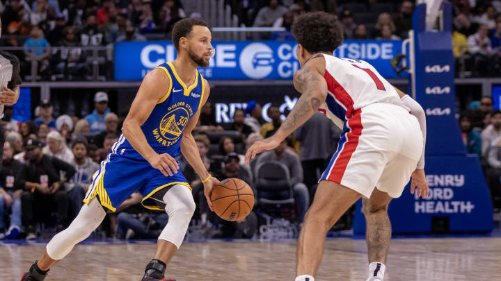 Nov 6, 2023; Detroit, Michigan, USA; Golden State Warriors guard Stephen Curry (30) moves the ball up court on Detroit Pistons guard Killian Hayes (7) during the second half at Little Caesars Arena. Mandatory Credit: David Reginek-USA TODAY Sports