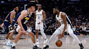 Apr 2, 2025; Denver, Colorado, USA; San Antonio Spurs guard Malaki Branham (22) controls the ball against Denver Nuggets forward Spencer Jones (21) as guard Chris Paul (3) and guard Jalen Pickett (24) defend in the second quarter at Ball Arena. Mandatory Credit: Isaiah J. Downing-Imagn Images
