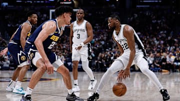 Apr 2, 2025; Denver, Colorado, USA; San Antonio Spurs guard Malaki Branham (22) controls the ball against Denver Nuggets forward Spencer Jones (21) as guard Chris Paul (3) and guard Jalen Pickett (24) defend in the second quarter at Ball Arena. Mandatory Credit: Isaiah J. Downing-Imagn Images