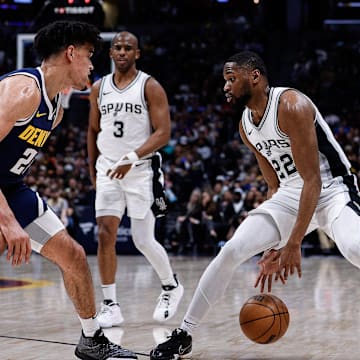 Apr 2, 2025; Denver, Colorado, USA; San Antonio Spurs guard Malaki Branham (22) controls the ball against Denver Nuggets forward Spencer Jones (21) as guard Chris Paul (3) and guard Jalen Pickett (24) defend in the second quarter at Ball Arena. Mandatory Credit: Isaiah J. Downing-Imagn Images