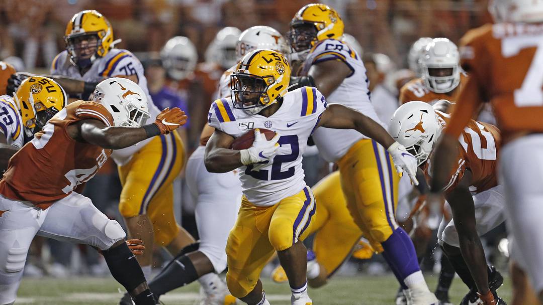 LSU Tigers running back Clyde Edwards-Helaire (22) looks for running room against the Texas Longhorns in the first half at Darrell K Royal-Texas Memorial Stadium.