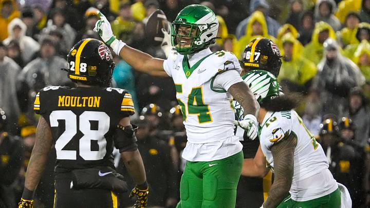 Oregon Ducks linebacker Jerry Mixon (54) singles first down for the Ducks after an Iowa Hawkeyes wide receiver Kaden Wetjen (21) fumble Nov. 8, 2025 during a Big Ten Football game at Kinnick Stadium in Iowa City, Iowa.