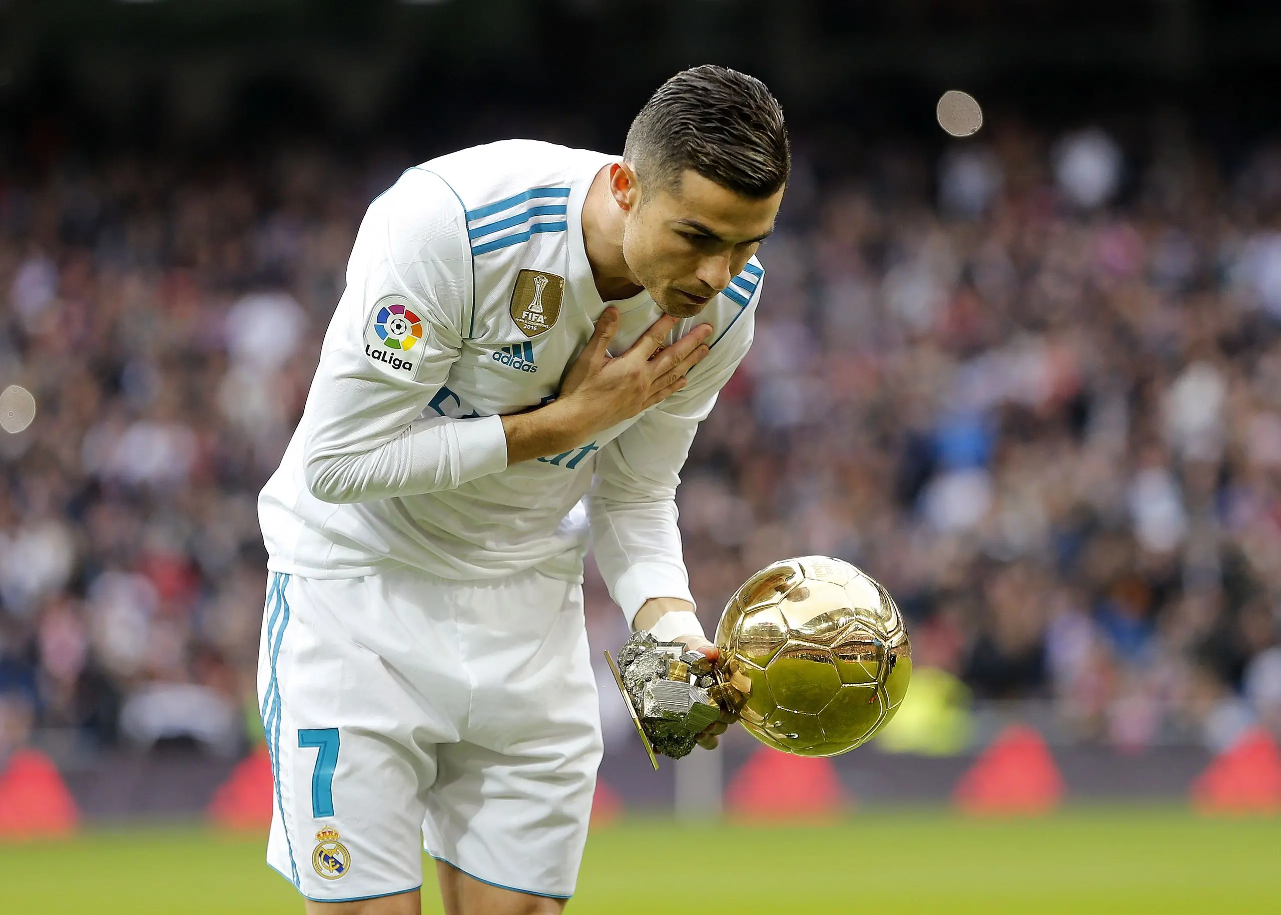 Cristiano Ronaldo of Real Madrid shows his recent won Golden Ball (Ballon d'Or) trophy prior to start the La Liga match.