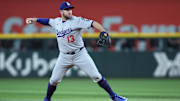 Apr 18, 2025; Arlington, Texas, USA; Los Angeles Dodgers third baseman Max Muncy (13) throws to first during the third inning against the Texas Rangers at Globe Life Field. Mandatory Credit: Tim Heitman-Imagn Images