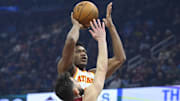 Jan 30, 2025; Cleveland, Ohio, USA; Atlanta Hawks forward De'Andre Hunter (12) shoots beside Cleveland Cavaliers guard Ty Jerome (2) in the first quarter at Rocket Mortgage FieldHouse. Mandatory Credit: David Richard-Imagn Images